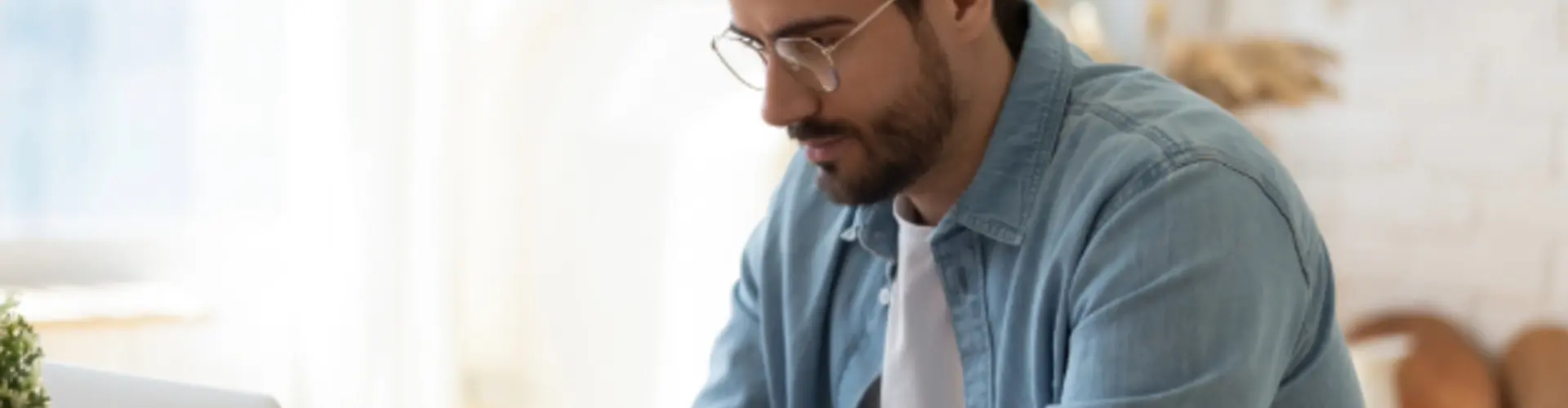 man looking at a laptop