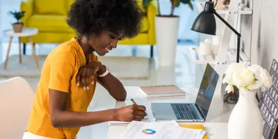 woman working at a desk with a laptop