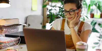 woman reading a laptop