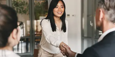 a woman shaking a mans hand