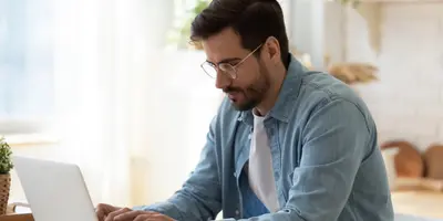 man looking at a laptop