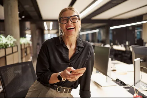 a smiling professional woman in an office
